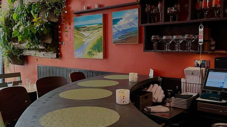 The four-seat bar at Vee Vee in Jamaica Plain is set with candles and green placemats