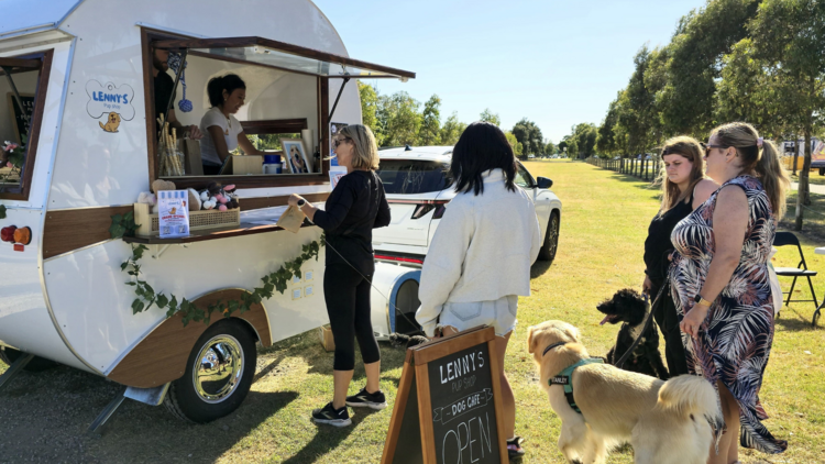 Queue of customers gathered with their dogs at Lenny's Pup Shop.