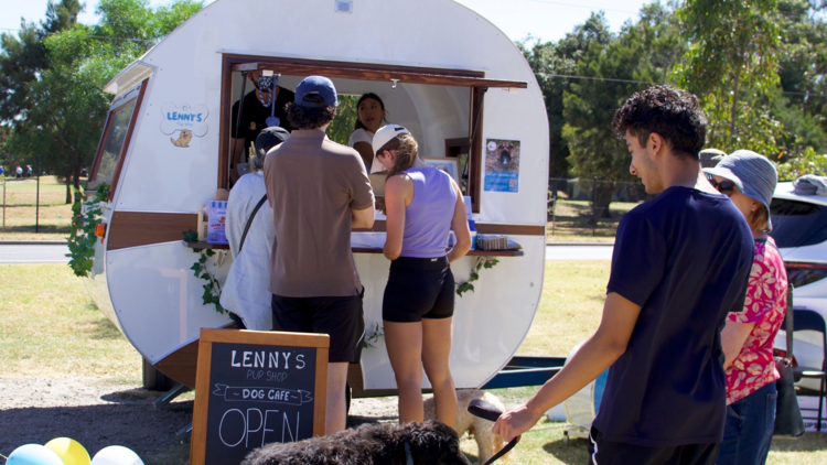 Queue of customers gathered with their dogs at Lenny's Pup Shop.