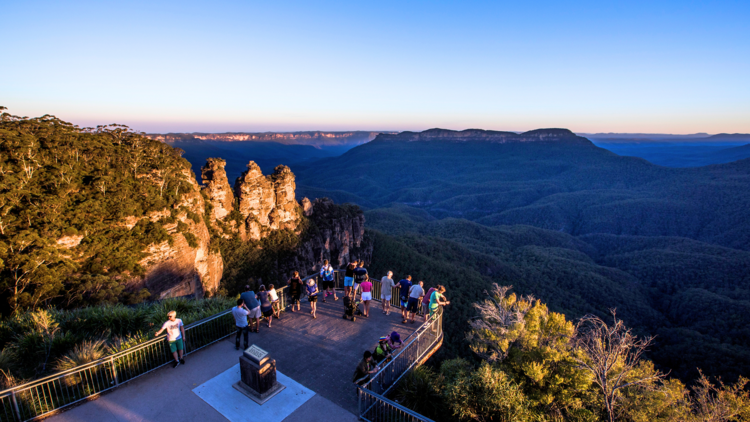 Tourists enjoying sunset views of The Three Sisters, Katoomba in the Blue Mountains.
