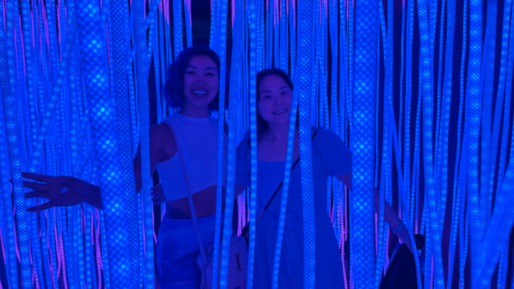 Two women surrounded by light tentacles