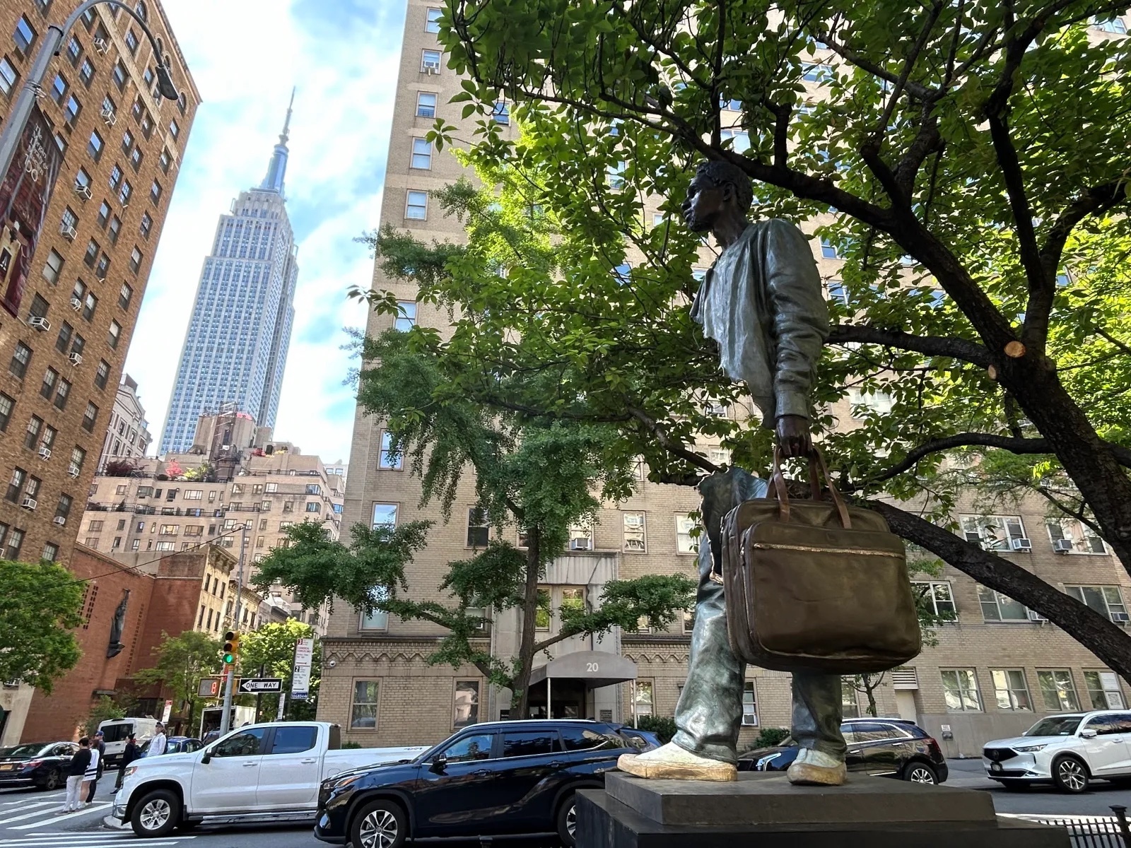 An illusion sculpture of a man with the Empire State Building in the background.