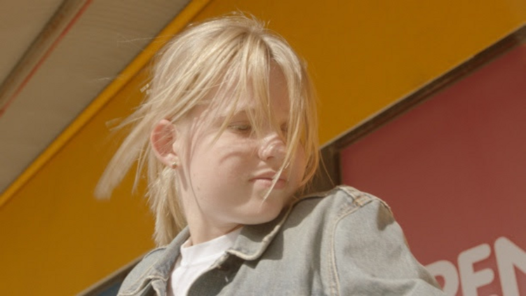 A blonde child in a still from the film Edie and Audrey