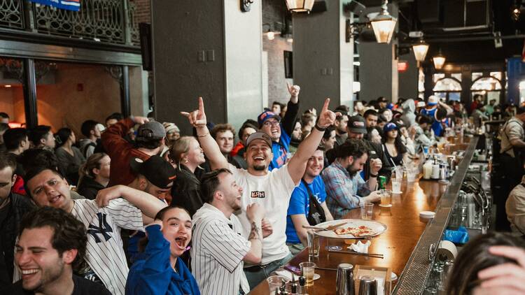 people cheer in a sports bar