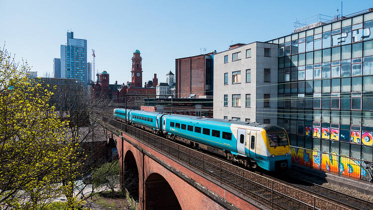 Train going over a bridge in Manchester, UK