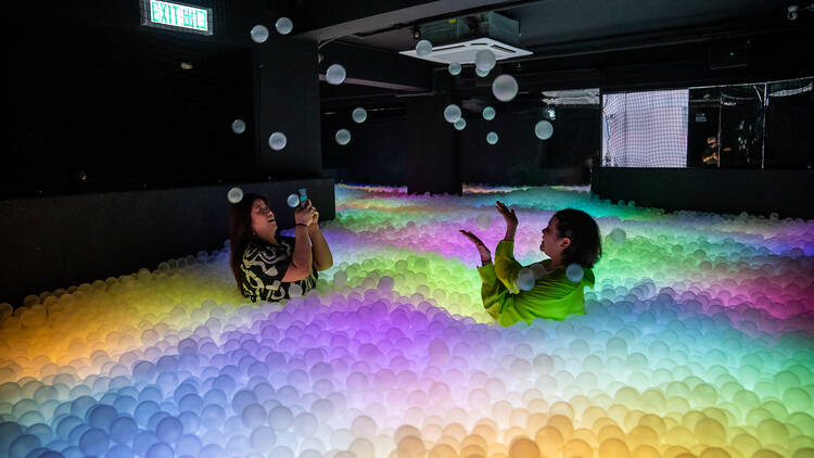 Dive into a ball pit at a bar