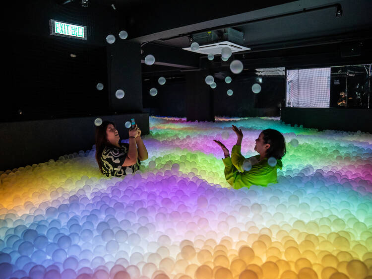 Dive into a ball pit at a bar