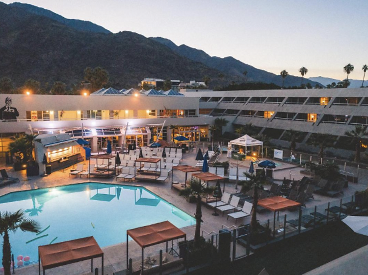 Outdoor pool surrounded by cabanas at Hotel Zoso, Palm Springs