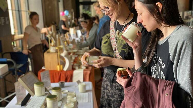 Shoppers sniff candles at the Boston Women's Market hosted at Time Out Market Boston.