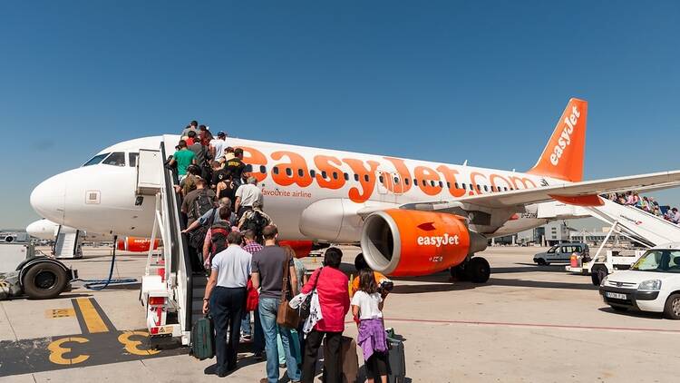 easyJet plane on the runway at Madrid Airport, with queue of passengers