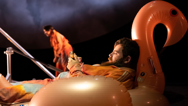 An actor reclines on an inflatable Flamingo