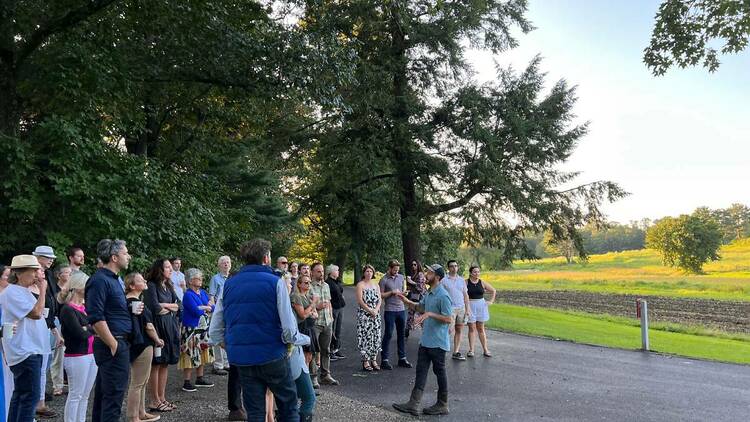 A crowd ready for a farm dinner gets a tour of Allandale Farm.