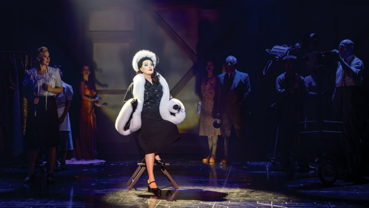 Sarah Brightman as Norma Desmond wears a glamorous fur outfit and hat