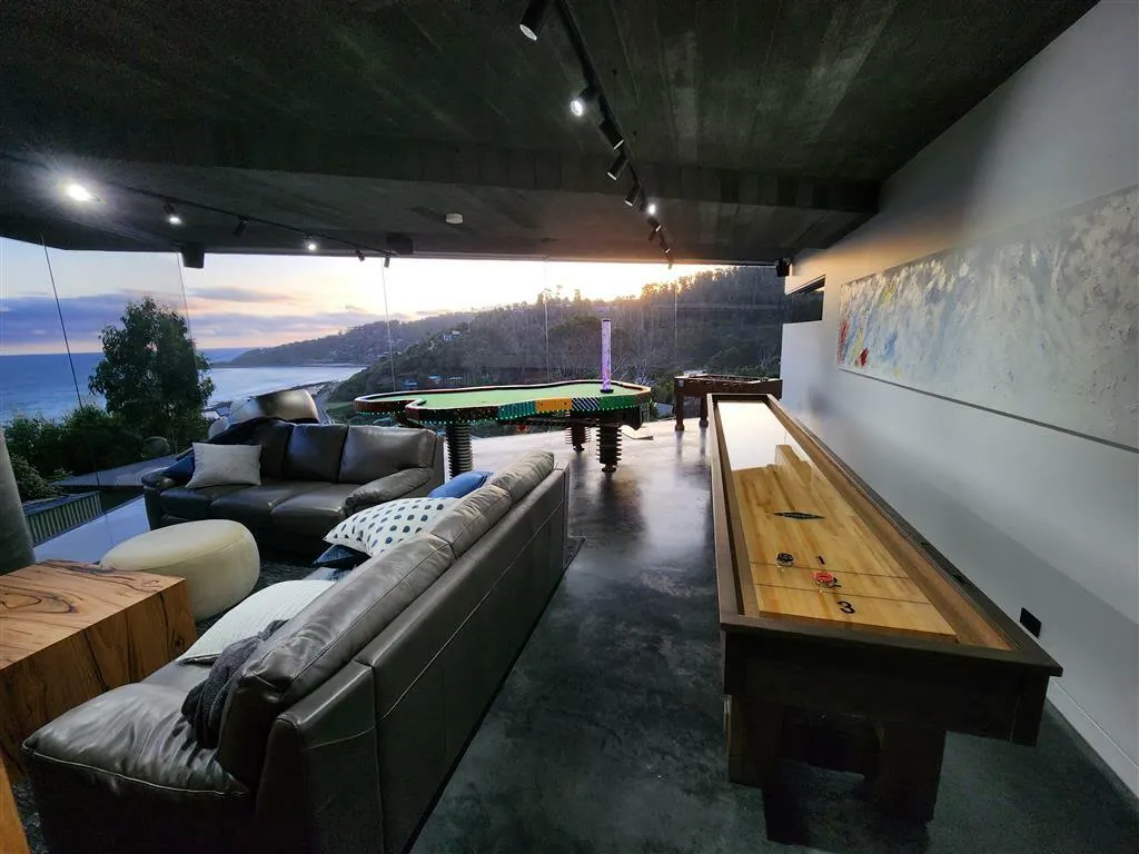 The interior of a home with living room future and a view out to the ocean.