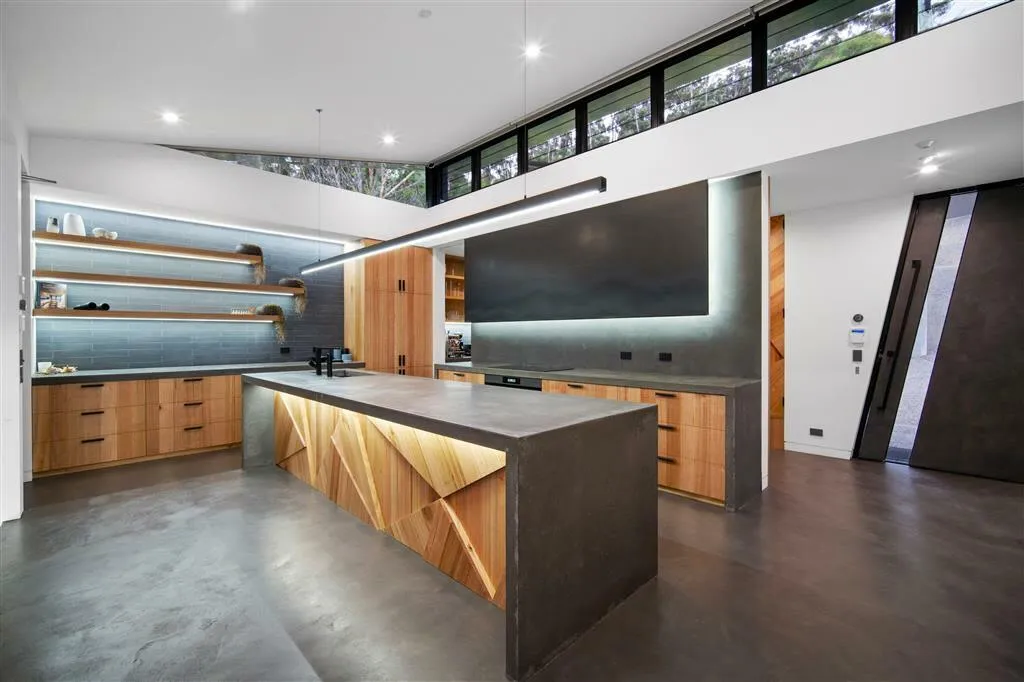 A modern kitchen, with timber paneling.