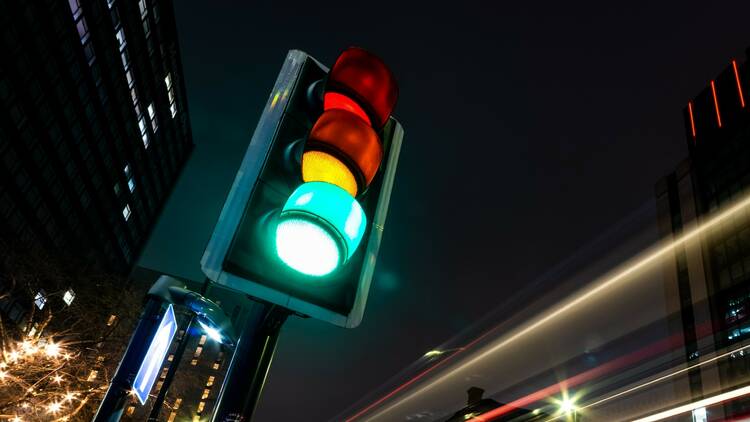 Traffic light at night in Manchester, UK