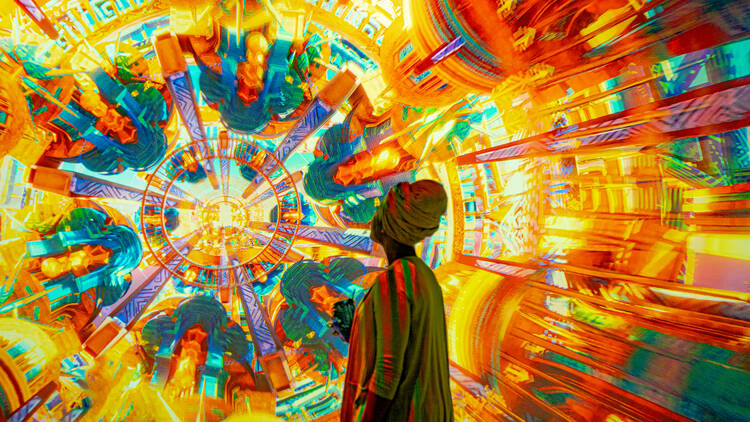 A woman looks at an immersive exhibit.