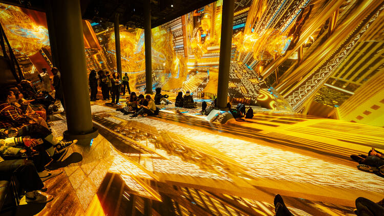 A golden-hued light show at an immersive exhibit.
