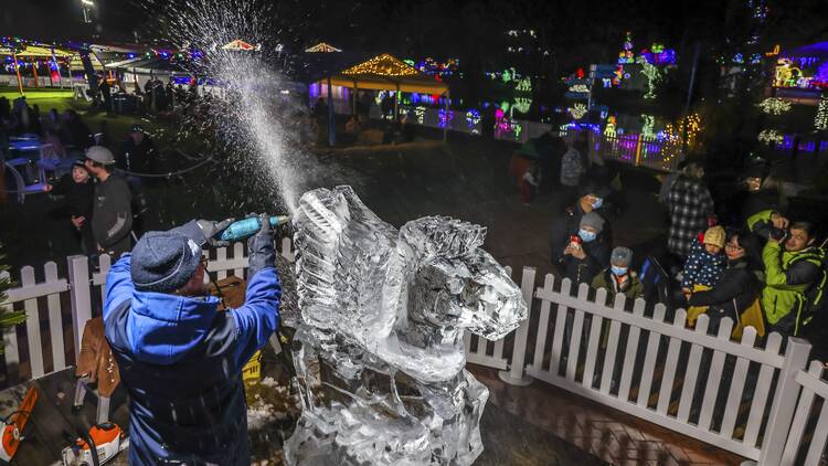 Man carves an ice sculpture