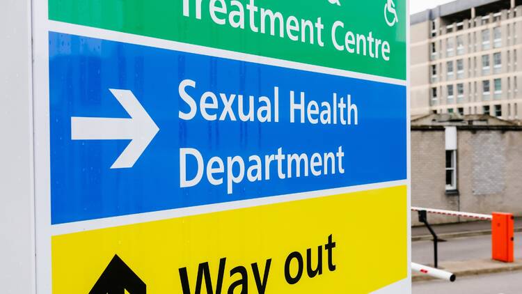 A sign leading to a sexual health clinic