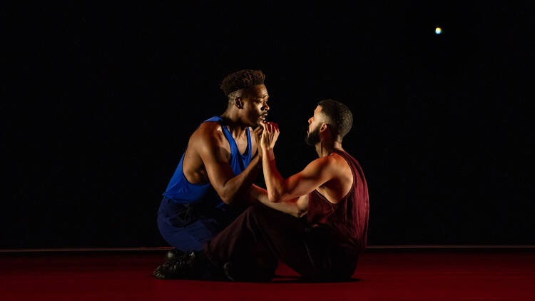 Two dancers sitting with eachother