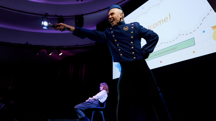 Performer points a microphone towards the crowd