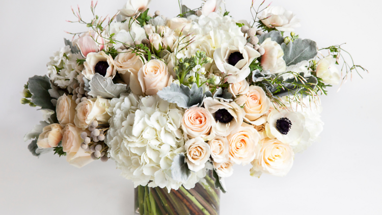 Dusty Whites floral arrangement in a vase.