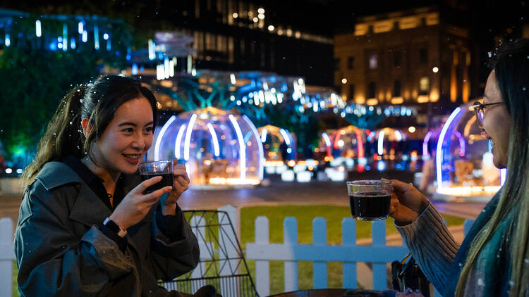 Two women drinking mulled wine