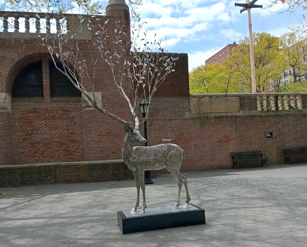 A deer sculpture with branches instead of antlers.