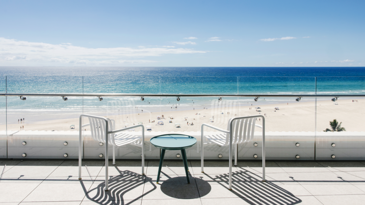 Outdoor balcony overlooking beach with two chairs