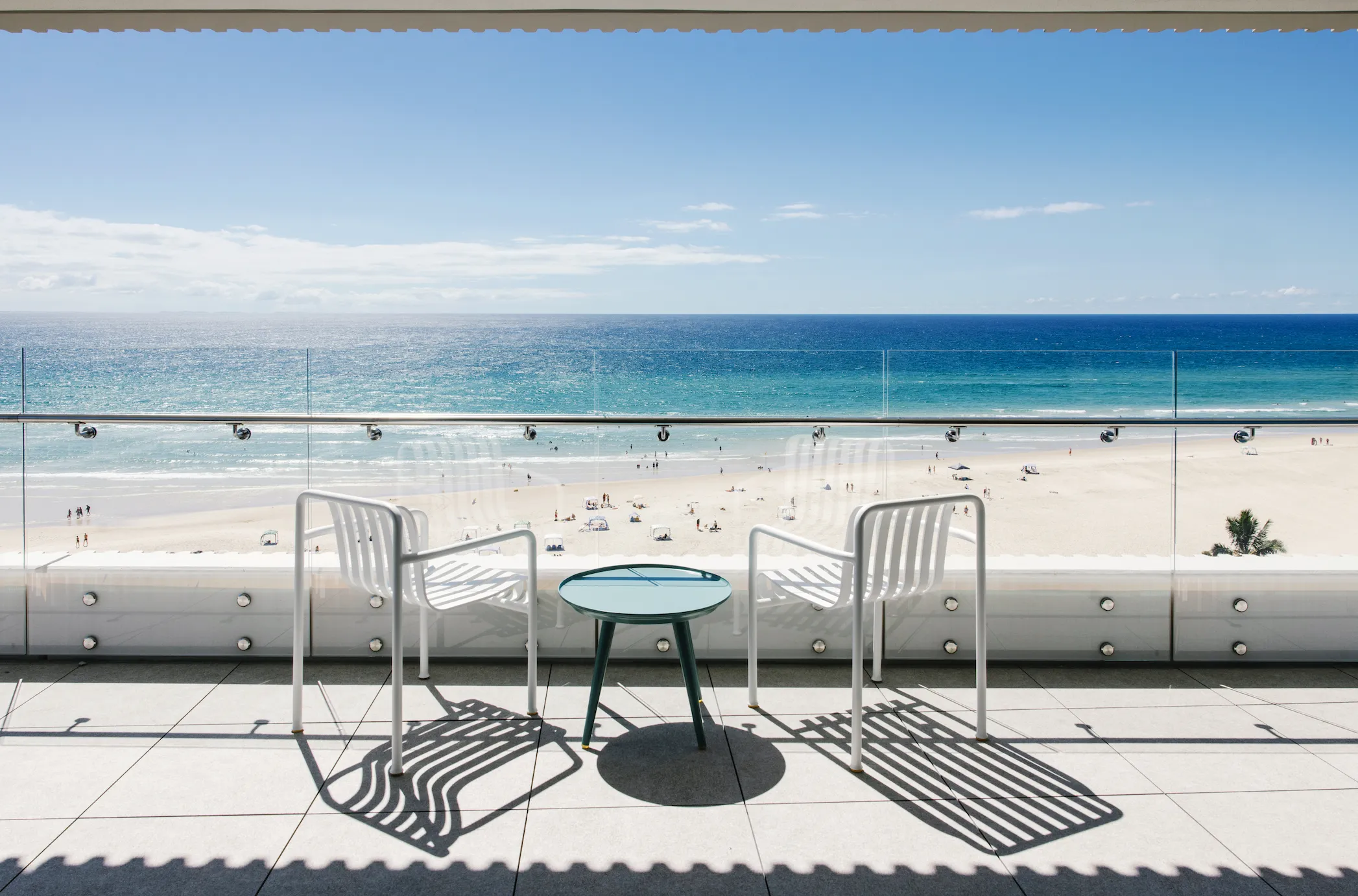 Outdoor balcony overlooking beach with two chairs