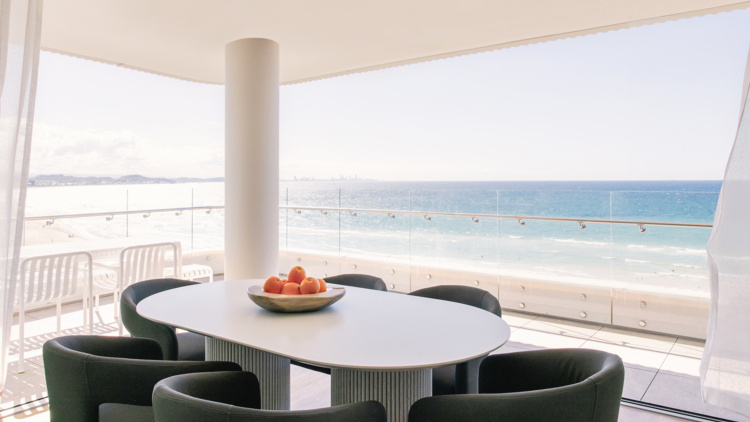 Outdoor balcony overlooking beach with table for six