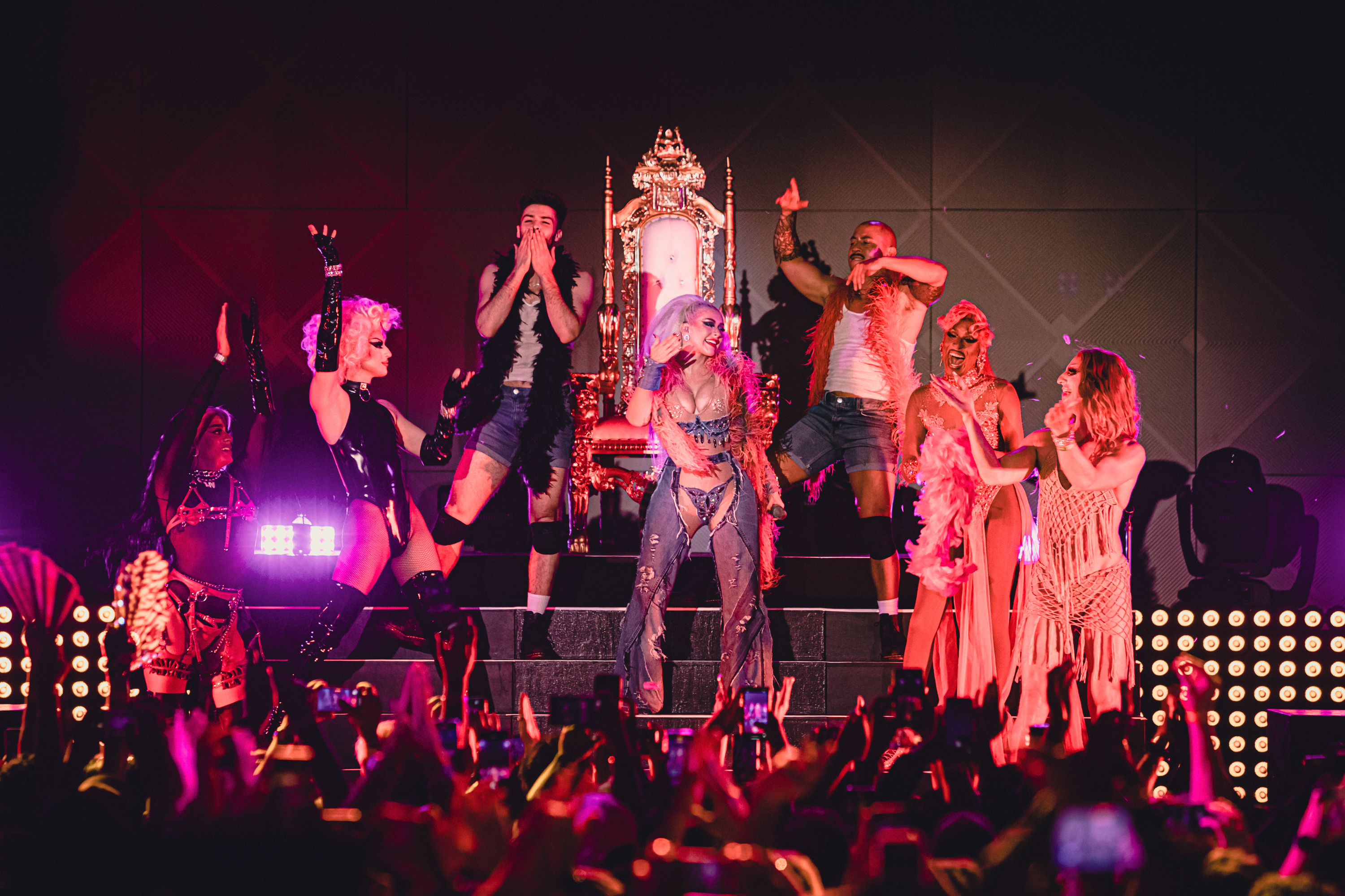 performer on a stage with dancers