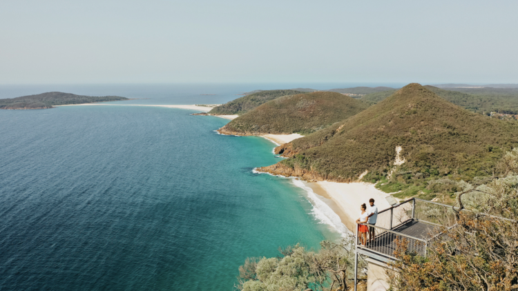 Couple enjoying the view at Tomaree Head Summit Walk, Port Stephens