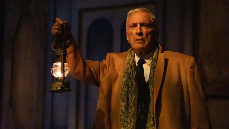 John Waters holds up a lantern