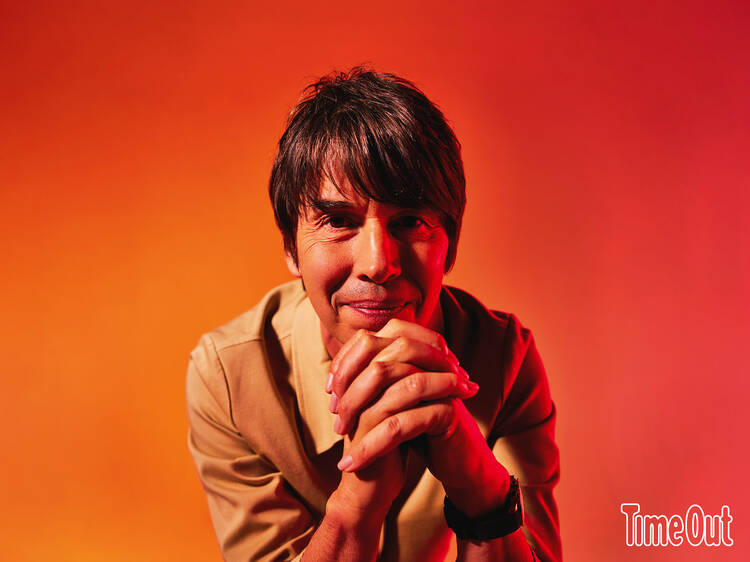 Brian Cox with a red backdrop