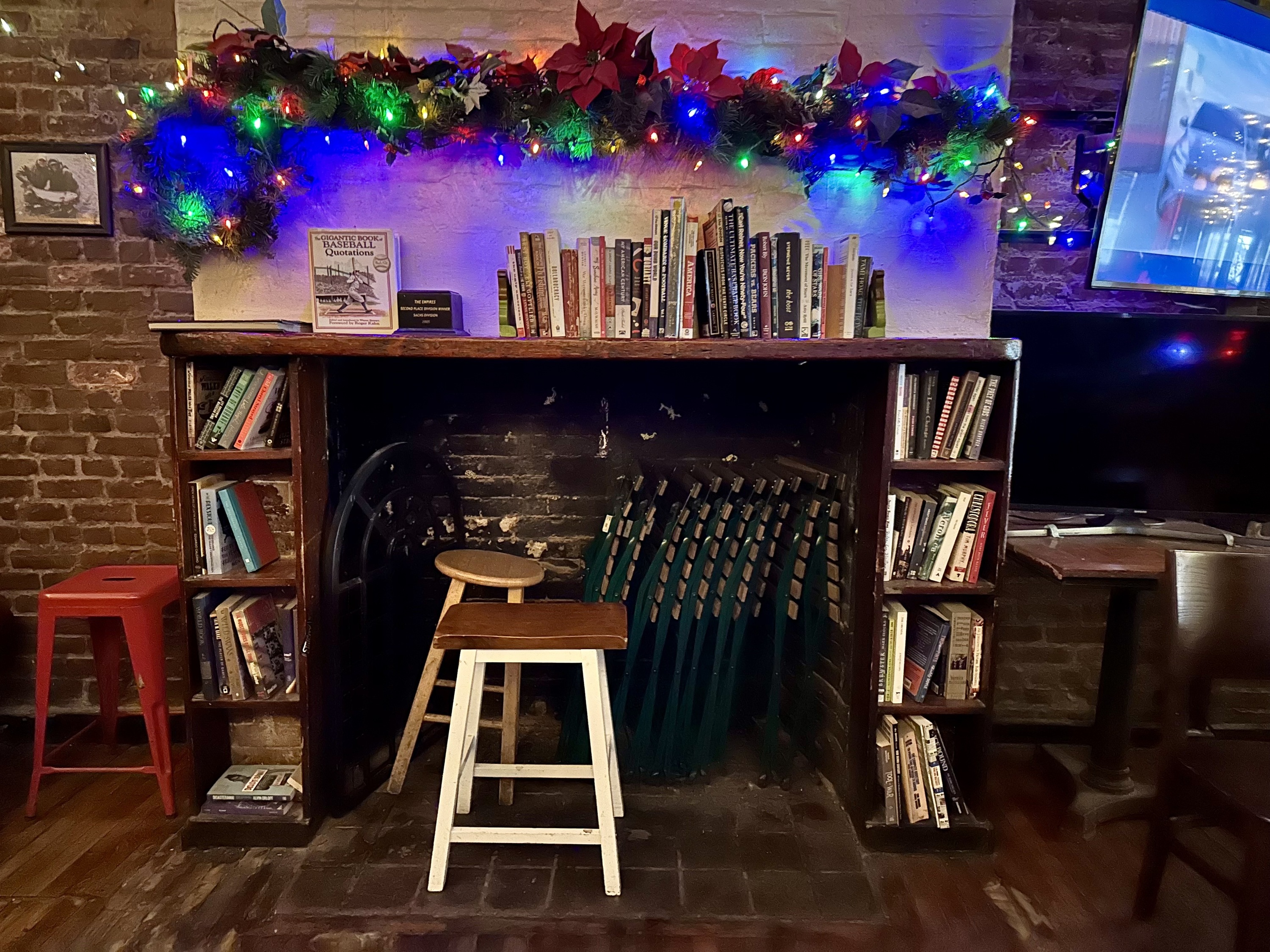 Inside a bar with a bookshelf.