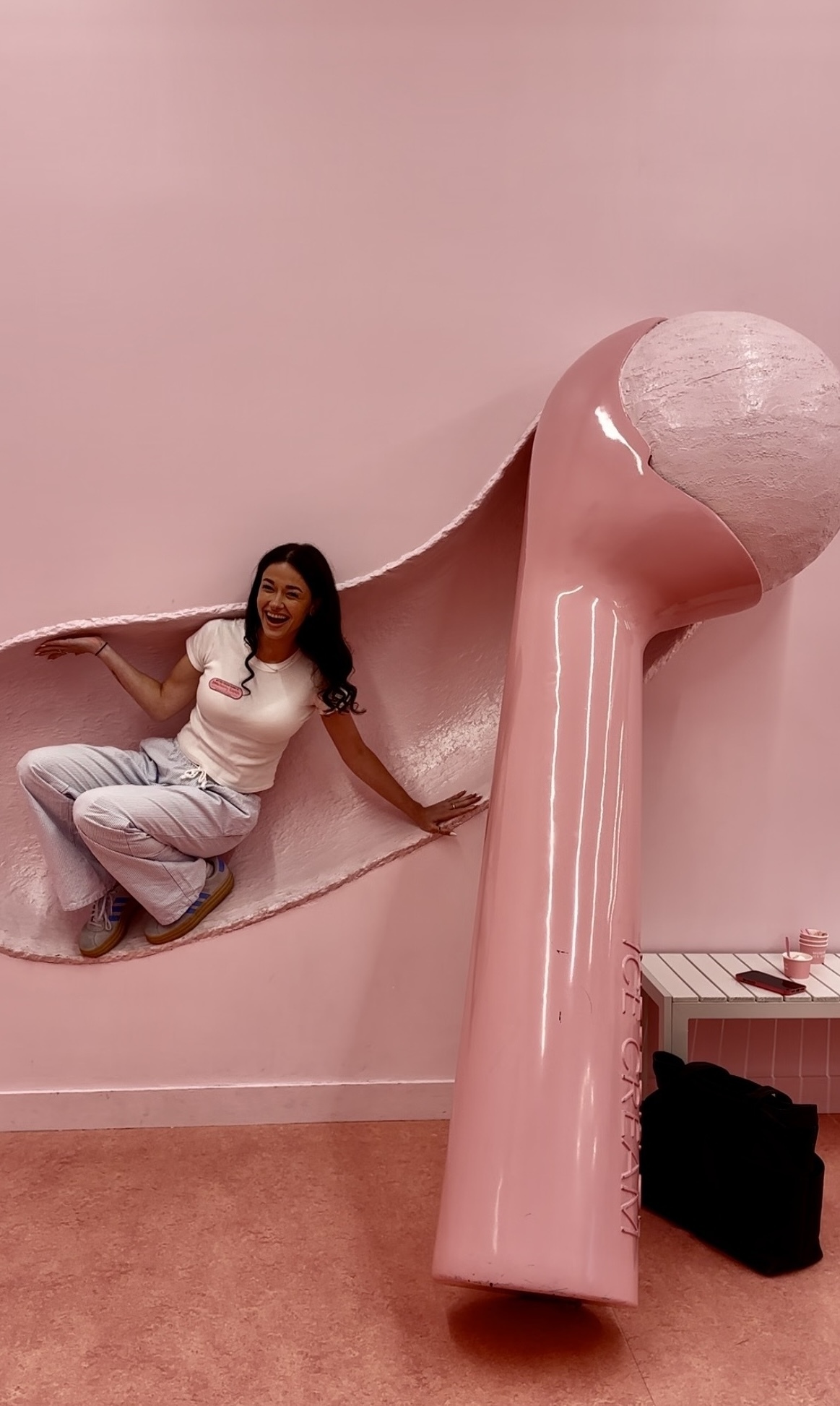 A woman poses inside a scoop of ice cream.