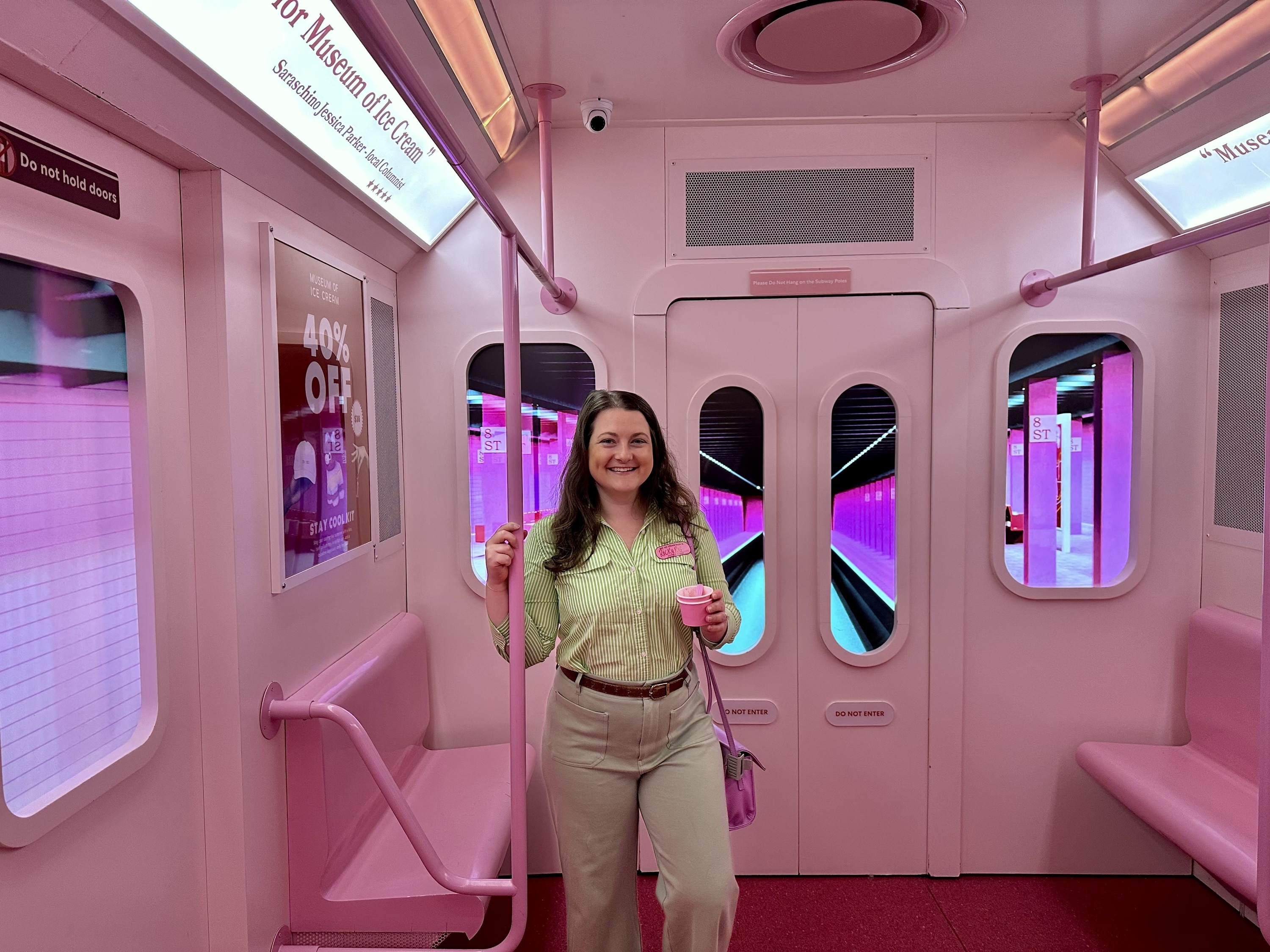 A woman in a pink subway display.