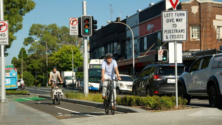 Bike riders cycling on Oxford Street cycleway through Bondi Junction