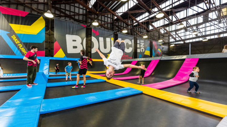 Kids jump up and down on trampolines