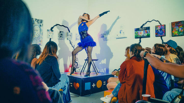 A performer in a blue outfit at an event.