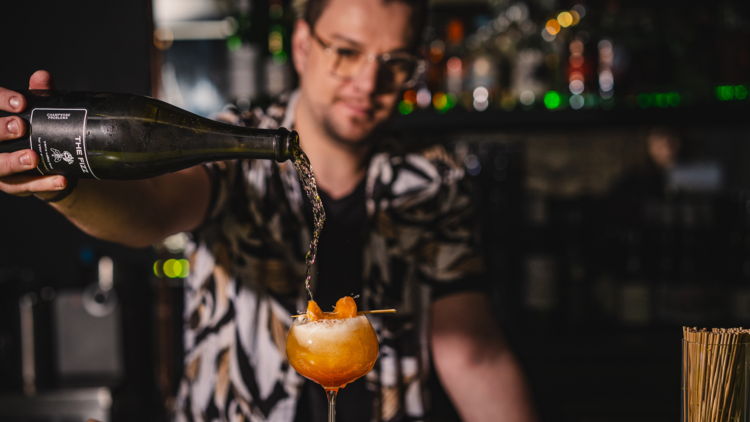 Bartender pouring a drink. 