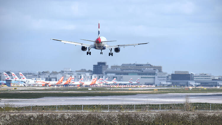 London Gatwick airport with plane landing on the runway