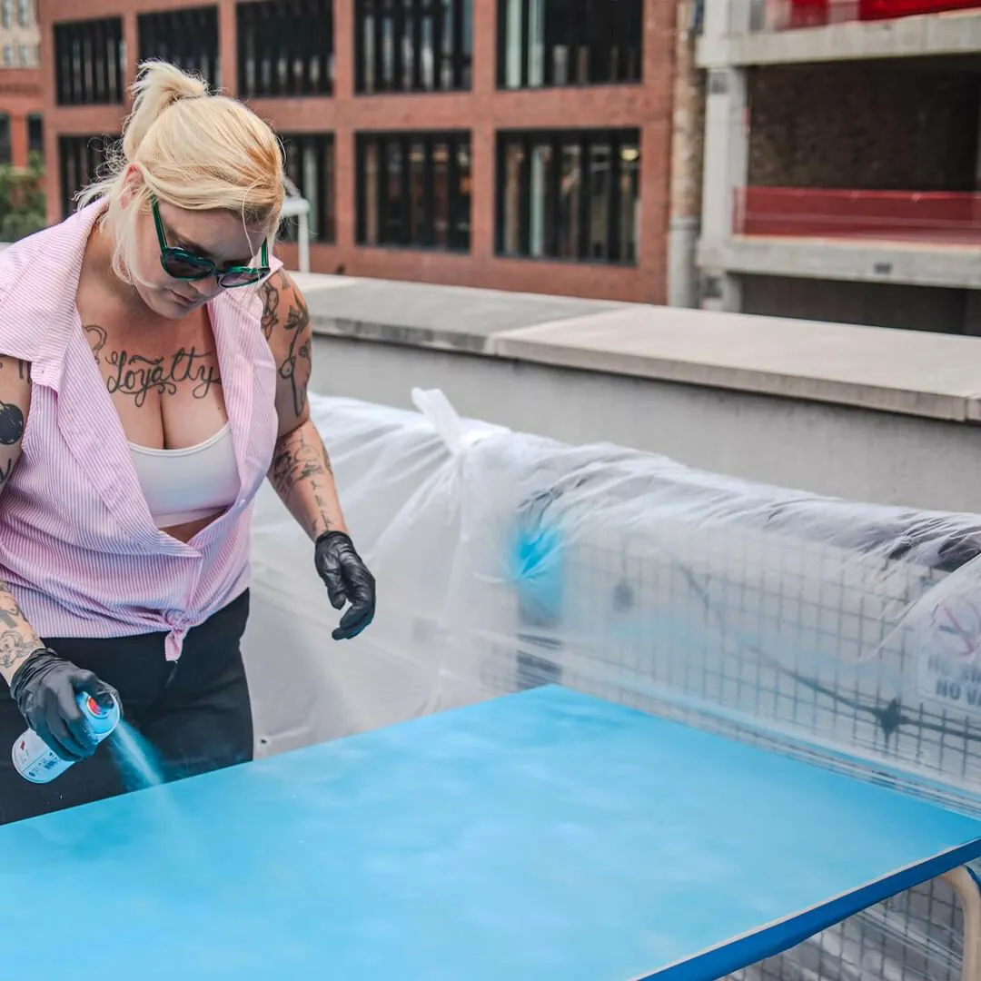 A person painting a table