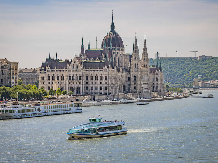 Boats sailing past the Parliament building in Budapest