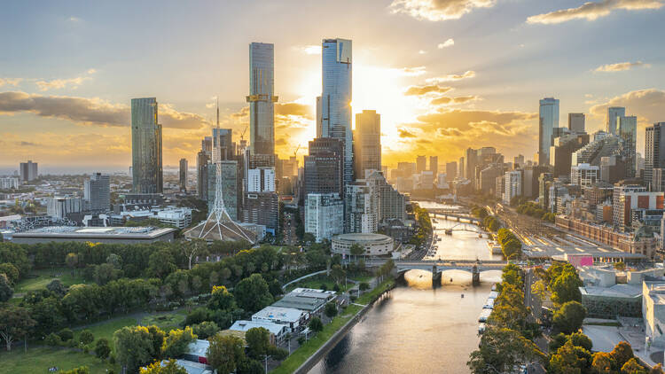 Melbourne's CBD skyline (including the Yarra River and Arts Centre) at sunset.