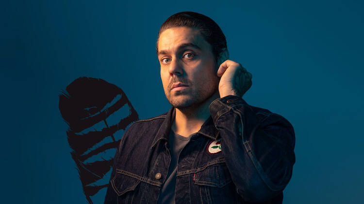 Dan Sultan in front of blue background 