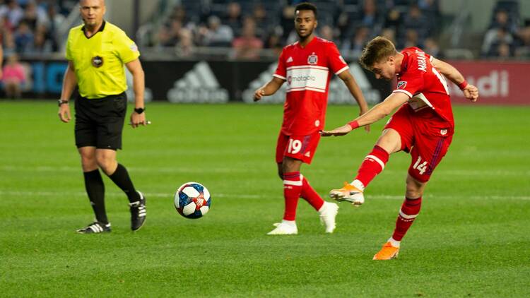 A soccer player kicking a ball