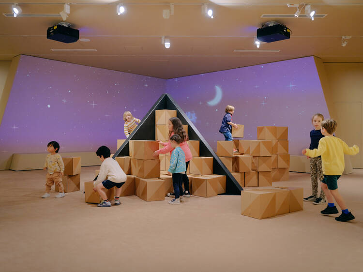 Children playing with blocks and building a pyramid. 